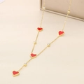 Long gold necklace with four red enamel hearts and clear zircon pendants on leather - Red