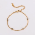 Elegante pulsera de cuentas doradas con circonitas claras y cierre de mosquetón ajustable - Dorado