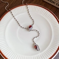Luxury silver Y-necklace featuring red pear-shaped zircons and elegant olive bead chain - Necklace-Silver-Red