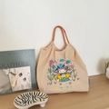 Detailed close-up of beige nylon tote bag with colorful sheep embroidery and woven handle - Beige Wishing Lamb