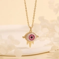 Detailed close-up of a 18K gold plated evil eye pendant with pink iris and golden spikes - Pink Purple Eye-A3