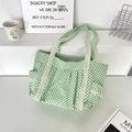 Detail of light green polka dot canvas tote with white lace trim and functional side pockets - Green