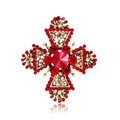 Close-up of golden cross brooch with red crystals and intricate openwork details - Red (B087-A)