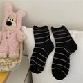 Black and brown striped mid-calf socks for women in Morandi style on white pillow - One Size / Black