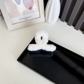 Faux rabbit fur white plush hair claw clip in a minimalist home setting decor - White