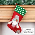 Red Christmas stocking with gnome embroidery and green cuff hanging on fireplace - Polka Dot Red Gnome Stocking