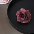 Large dark pink fabric rose hair clip and brooch displayed on a black wooden tray - Gejiao Rose / Burgundy