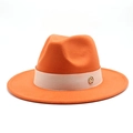 Close-up of orange wool fedora with beige decorative band and gold letter M logo - Orange