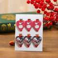Detailed view of six heart-shaped wooden Christmas clips with festive patterns and text - Heart Style
