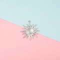 Detailed view of a shiny silver sun charm pendant with wavy rays on a split background - Hollow Sun Rays Style (6#)
