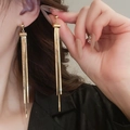 Elegant gold-plated long tassel earrings worn by a model to show fluid linear movement - 18K Gold Plated Silver Earring Post Embossed Tassel (20#)