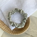 Elegant sage green satin hair scrunchie with smooth silk texture for women hairstyles - Pale Green