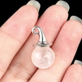 Pink translucent crystal witch hat pendant with silver metal bail on black background - White Crystal