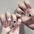 Close-up of press-on nails featuring cute black cat and star patterns with meow text - By1560 Black Cat Music / Glue Type