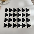 Close-up of modern rectangular placemat with black and white geometric triangle pattern - Black Triangle