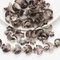 Close-up of moon and star glass beads in translucent smoky gray with gold glitter DIY parts - Dark Gold