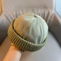 Detail view of Miki hat showing dark green twill fabric and thick ribbed knit texture - Adjustable / Light Green Knit Edge Skull Cap