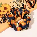 Detail of Halloween scrunchie with pumpkin prints and Happy Halloween text on satin fabric - Navy Pumpkin / Large Size