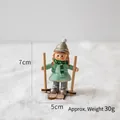 Skiing girl figurine with mint dress and grey hat on snow background, 7cm height - Skiing Girl Figurine (30g)