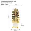Golden monstera leaf metal ornament with clear crystal ball and three-legged base - Slender Monstera Leaf - Crystal Ball