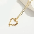 Elegant gold fine chain necklace with heart pendant and ruby-colored stone accents - Hollow Heart / Gold
