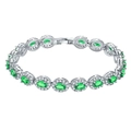 Macro shot of silver vintage bracelet featuring green oval gemstones with diamond halo - Platinum Green Zirconia