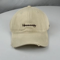 Detail of embroidered Haaaaapy letters and distressed ripped brim on beige baseball cap - One Size (58-60cm) / Beige