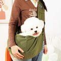 Detail view of army green cotton canvas pet sling carrier worn in a home setting - Army Green