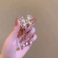 Detail of golden butterfly hair claw with white pearls and long hanging tassels - Ethereal Pearl Butterfly 3 Tassels