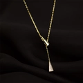 Close-up of a gold Y-necklace with two triangle pendants on black satin background - Gold