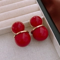 Chic red double-sphere earrings with gold rings on a textured jewelry display box - Double Layer Red Ball Earrings