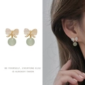 Detail of vintage bow earrings with bean green beads and model wearing demonstration - Bow Bead Pearl Clip-on