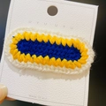Handmade crochet hair clip in blue, yellow, and white knit patterns on a card display - 13# Yellow Blue Oval Slice