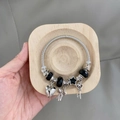 DIY beaded stainless steel bracelet with black faceted beads and silver heart charms - Black Bow Bangle