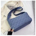 Close-up of blue quilted corduroy tote bag showing rhombic texture and wide strap - Blue