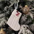 White knitted Christmas stocking with red letter Z embroidery on a festive tree branch - Embroidered Knitted Small Sock White Z