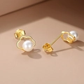 Macro shot of S925 sterling silver butterfly bow earring with a polished white pearl - Gold Cloud Pearl Studs