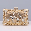 Detail of golden evening clutch with hollow metal flowers and sparkling rhinestones - Gold