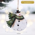 Handcrafted iron snowman ornament with a green polka dot scarf and vintage finish - Snowman No.3