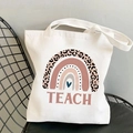 Close-up of off-white canvas tote bag featuring leopard rainbow and TEACH print - Boho Leopard TEACH