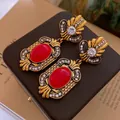 Detail of vintage gold earrings with large red gemstones and baroque floral patterns - 9# Silver Needle - Red - Flower