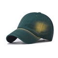 Detailed close-up of dark green washed cotton baseball cap with yellow distressed finish - Distressed Green / Adjustable