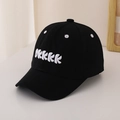 Close-up of OKKKK letter embroidery and ventilation eyelets on a black cotton baseball cap - 48-52cm (2-6 Years) / Black