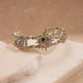 Detailed macro view of woven green and white cord wrapping around silver metal bangle - Silver