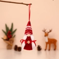 Detail of red knitted Christmas gnome ornament with white braids and wooden buttons - Female - Style 1