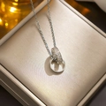 Interlocking silver rings necklace with pavé cubic zirconia on a brushed metal background - 8976 Steel Color Double Ring