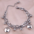 Close-up of silver double-layered stainless steel bracelet with heart pendants on silk - Double Layer Heart Beads / Silver