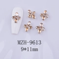 Detail view of 9x11mm amber floral alloy nail gems shown on a white manicure tip - Champagne Gem - Silver Base (MZH-9613)