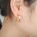Close-up of minimalist S925 sterling silver gold-plated hoop earring worn on an ear - EH-276-Gold