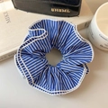 Blue and white striped fabric scrunchie with pleated texture shown on an open book - Blue Stripes 4-Layer